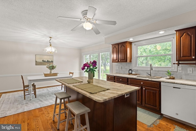 98 Magnificent Ln, Hedgesville, WV 25427 - kitchen featuring a sink, white dishwasher, crown molding, a textured ceiling, and decorative backsplash