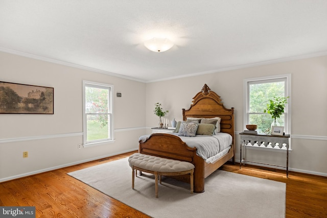 98 Magnificent Ln, Hedgesville, WV 25427 - bedroom with multiple windows, ornamental molding, wood finished floors, and baseboards