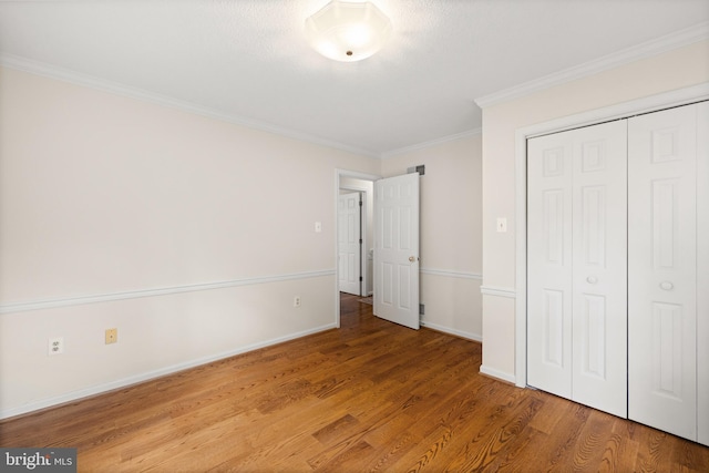 98 Magnificent Ln, Hedgesville, WV 25427 - unfurnished bedroom with crown molding, wood finished floors, baseboards, and a closet