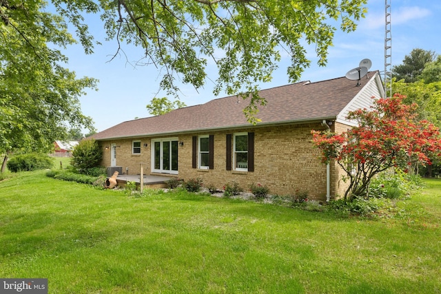 98 Magnificent Ln, Hedgesville, WV 25427 - back of house featuring a patio area, a yard, brick siding, and roof with shingles