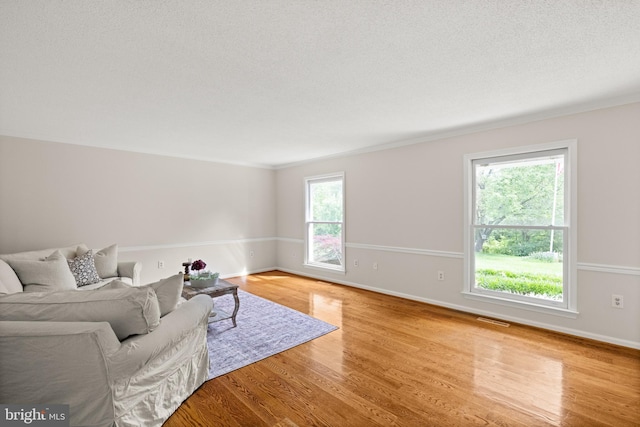 98 Magnificent Ln, Hedgesville, WV 25427 - living room with wood finished floors, baseboards, crown molding, and a textured ceiling