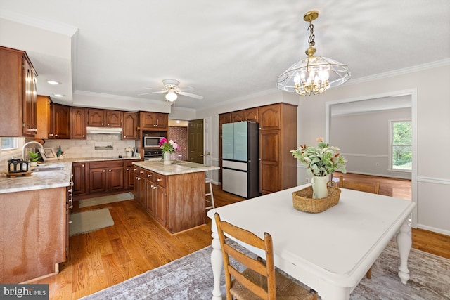 98 Magnificent Ln, Hedgesville, WV 25427 - kitchen with appliances with stainless steel finishes, a sink, under cabinet range hood, light countertops, and wood finished floors