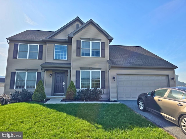 125 Nantucket Dr, Reading, PA 19605 - view of front of home with driveway, a garage, a front yard, and a shingled roof