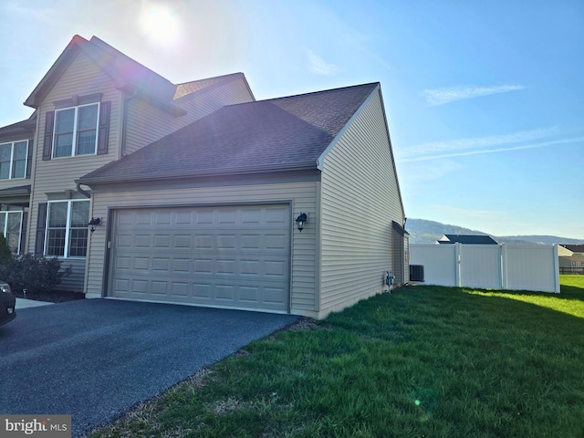 125 Nantucket Dr, Reading, PA 19605 - view of property exterior with driveway, an attached garage, a shingled roof, and central AC unit