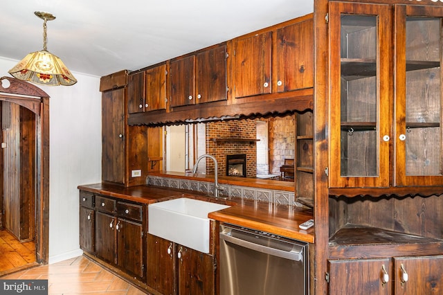 6908 S Roxbury Mill Rd, Spotsylvania, VA 22551 - kitchen with stainless steel dishwasher, a sink, glass insert cabinets, decorative light fixtures, and a fireplace
