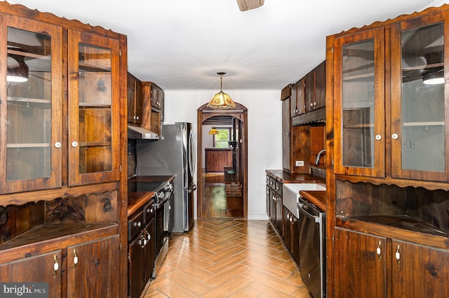 6908 S Roxbury Mill Rd, Spotsylvania, VA 22551 - kitchen with appliances with stainless steel finishes, ventilation hood, a sink, glass insert cabinets, and baseboards