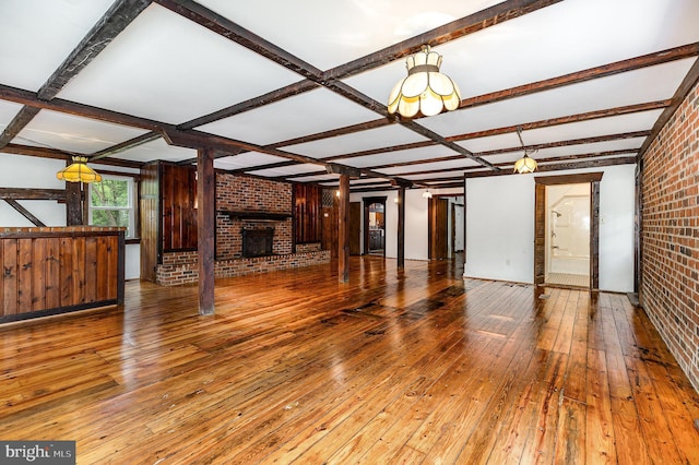 6908 S Roxbury Mill Rd, Spotsylvania, VA 22551 - unfurnished living room with brick wall, wood-type flooring, a brick fireplace, beamed ceiling, and coffered ceiling