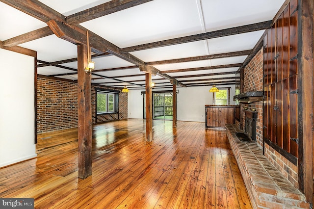 6908 S Roxbury Mill Rd, Spotsylvania, VA 22551 - unfurnished living room featuring hardwood / wood-style flooring, plenty of natural light, a brick fireplace, beamed ceiling, and coffered ceiling