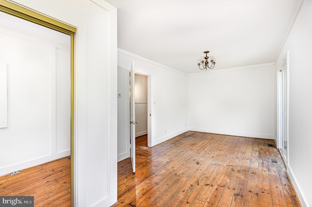 6908 S Roxbury Mill Rd, Spotsylvania, VA 22551 - spare room with a chandelier, hardwood / wood-style flooring, ornamental molding, and baseboards