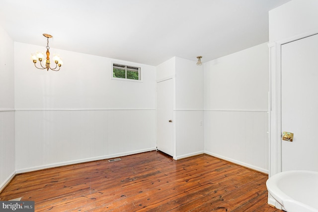 6908 S Roxbury Mill Rd, Spotsylvania, VA 22551 - spare room with hardwood / wood-style flooring, a chandelier, and a wainscoted wall