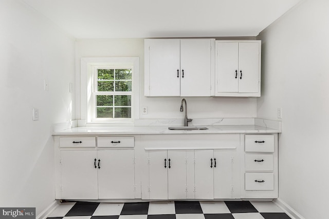 6908 S Roxbury Mill Rd, Spotsylvania, VA 22551 - kitchen with tile patterned floors, a sink, white cabinetry, and light countertops
