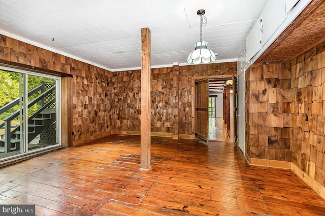 6908 S Roxbury Mill Rd, Spotsylvania, VA 22551 - empty room with wood walls and hardwood / wood-style flooring