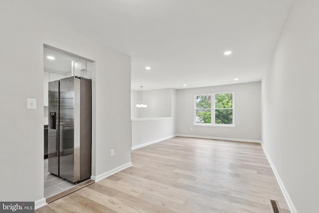 1205 Mirga Cir, Baltimore, MD 21207 - unfurnished room featuring light wood-style flooring, a chandelier, recessed lighting, and baseboards