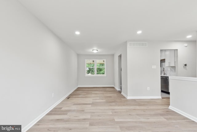 1205 Mirga Cir, Baltimore, MD 21207 - spare room featuring recessed lighting, light wood-style flooring, baseboards, and a sink