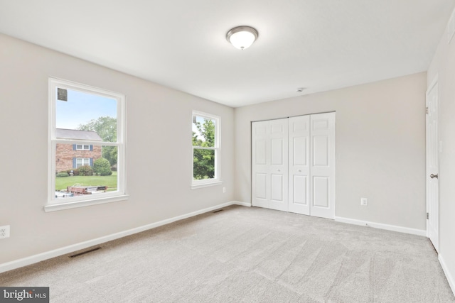 1205 Mirga Cir, Baltimore, MD 21207 - unfurnished bedroom featuring baseboards, a closet, and carpet floors