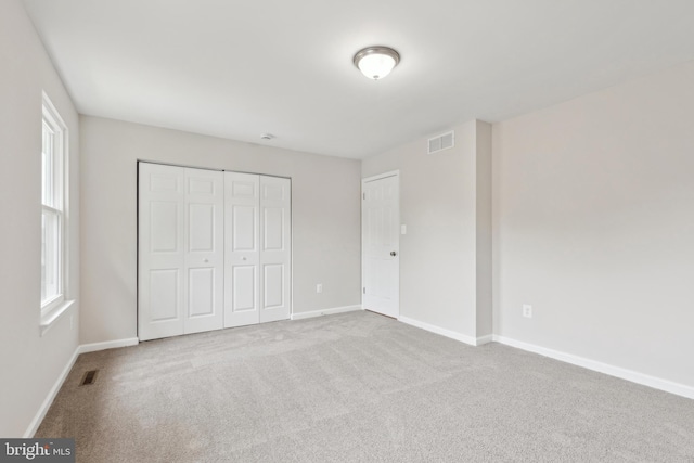 1205 Mirga Cir, Baltimore, MD 21207 - unfurnished bedroom with carpet floors, baseboards, a closet, and multiple windows