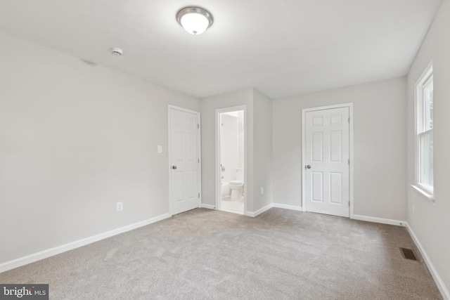 1205 Mirga Cir, Baltimore, MD 21207 - unfurnished bedroom with carpet floors, baseboards, and ensuite bathroom