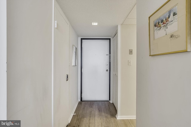 506 Brandywine House Rd Unit 506S, Bethany Beach, DE 19930 - hallway featuring hardwood / wood-style floors, baseboards, and a textured ceiling