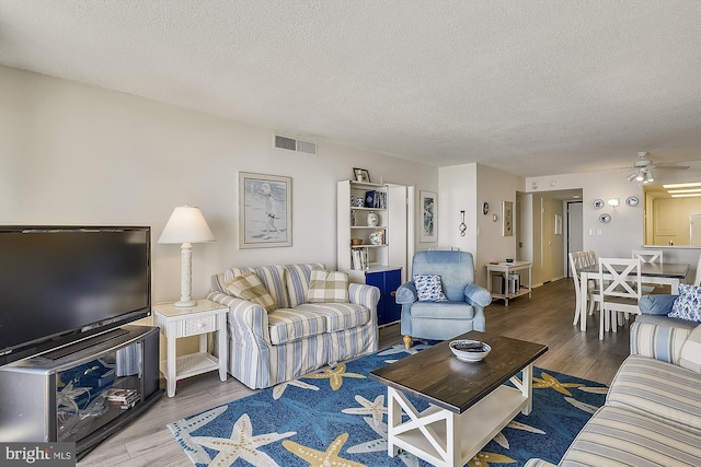506 Brandywine House Rd Unit 506S, Bethany Beach, DE 19930 - living room with wood finished floors, a textured ceiling, and ceiling fan