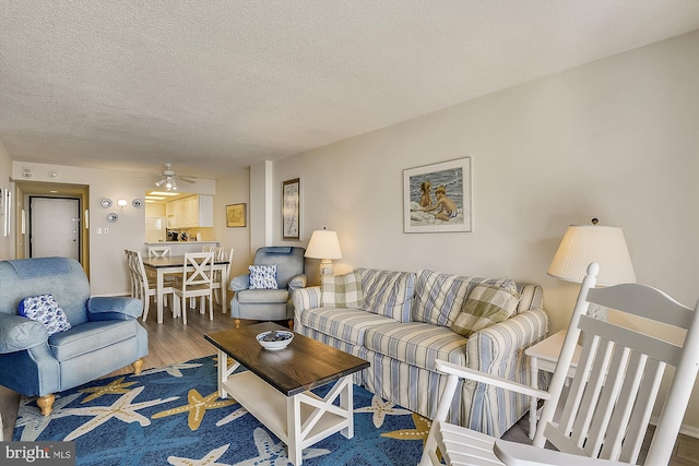 506 Brandywine House Rd Unit 506S, Bethany Beach, DE 19930 - living room featuring wood finished floors, a textured ceiling, and a ceiling fan