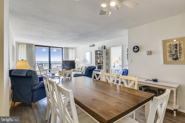 506 Brandywine House Rd Unit 506S, Bethany Beach, DE 19930 - dining space featuring a textured ceiling, wood finished floors, and a ceiling fan
