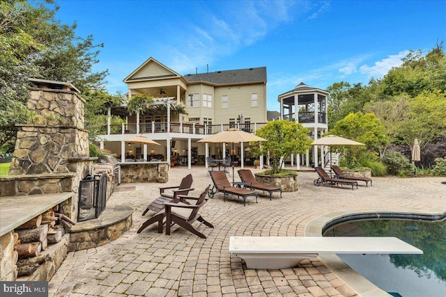 27422 Bridle Pl, Chantilly, VA 20152 - back of property with a balcony, a patio area, and an outdoor pool