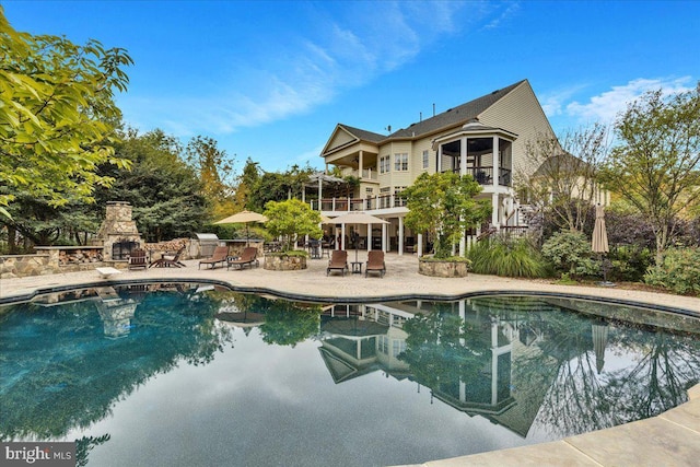 27422 Bridle Pl, Chantilly, VA 20152 - swimming pool with a patio area and a stone fireplace