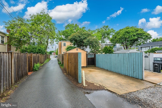 303 N W St, Alexandria, VA 22314 - view of asphalt alley featuring a gate