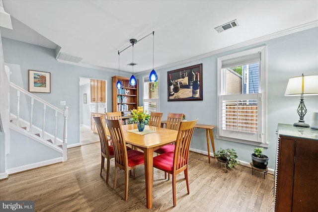303 N W St, Alexandria, VA 22314 - dining room featuring baseboards, stairs, crown molding, and light wood-style flooring