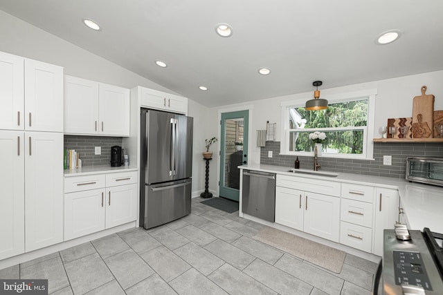 7 High St, Phoenixville, PA 19460 - kitchen with stainless steel appliances, a sink, tasteful backsplash, light countertops, and white cabinets