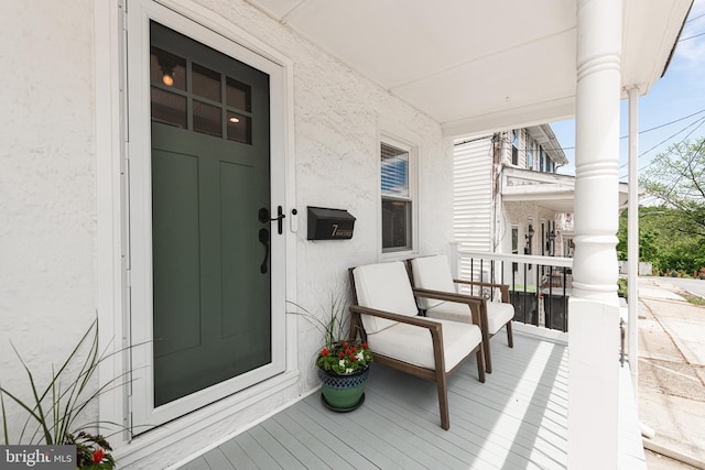 7 High St, Phoenixville, PA 19460 - doorway to property with stucco siding and a porch