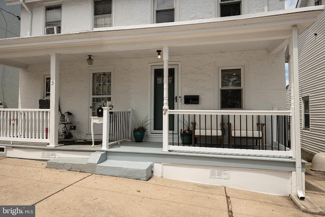 7 High St, Phoenixville, PA 19460 - doorway to property featuring covered porch and stucco siding