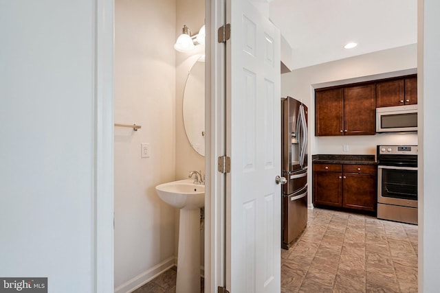 45812 Winding Branch Ter, Sterling, VA 20166 - bathroom featuring a sink and baseboards