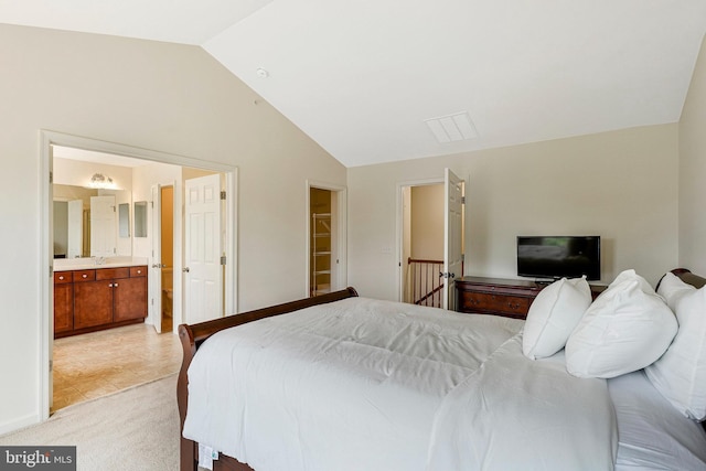 45812 Winding Branch Ter, Sterling, VA 20166 - bedroom with lofted ceiling, light carpet, and ensuite bath
