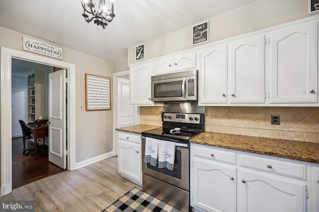 7600 Charleston Dr, Bethesda, MD 20817 - kitchen featuring stainless steel appliances, white cabinetry, and light wood-style flooring