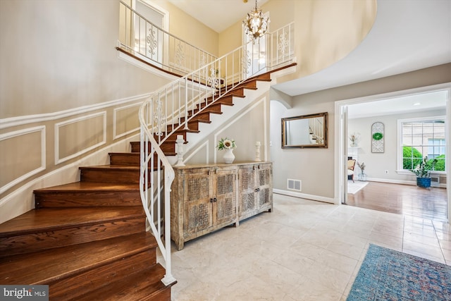 7600 Charleston Dr, Bethesda, MD 20817 - stairs with a decorative wall, a chandelier, tile patterned floors, and a high ceiling