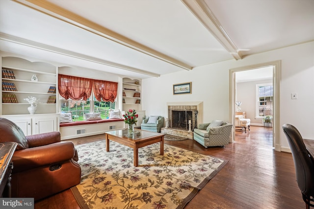7600 Charleston Dr, Bethesda, MD 20817 - living room with plenty of natural light, beamed ceiling, dark wood-style floors, and a brick fireplace
