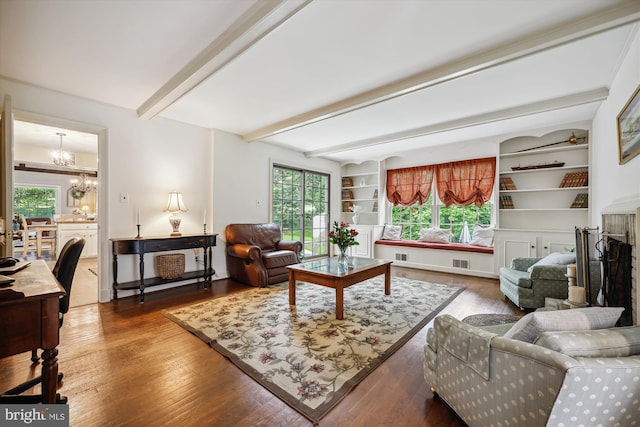 7600 Charleston Dr, Bethesda, MD 20817 - living room with a chandelier, beam ceiling, wood finished floors, and built in shelves