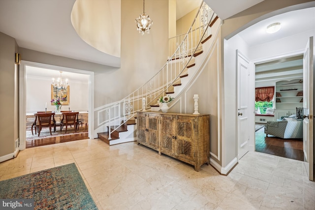 7600 Charleston Dr, Bethesda, MD 20817 - entryway featuring a chandelier, stairs, and arched walkways