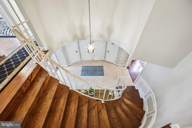 7600 Charleston Dr, Bethesda, MD 20817 - staircase featuring arched walkways and a chandelier