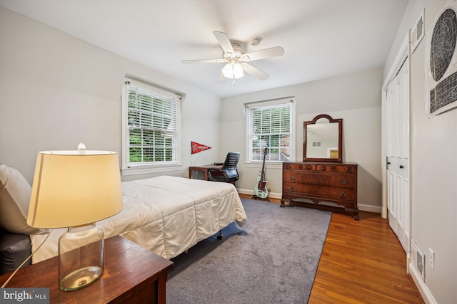 7600 Charleston Dr, Bethesda, MD 20817 - bedroom with wood finished floors, multiple windows, a closet, and ceiling fan