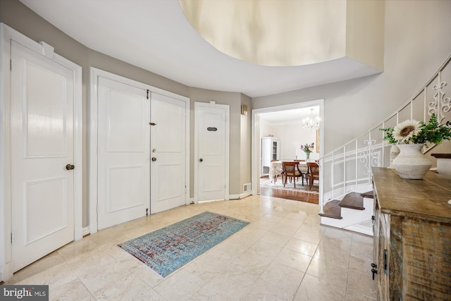 7600 Charleston Dr, Bethesda, MD 20817 - foyer entrance featuring stairway and a chandelier