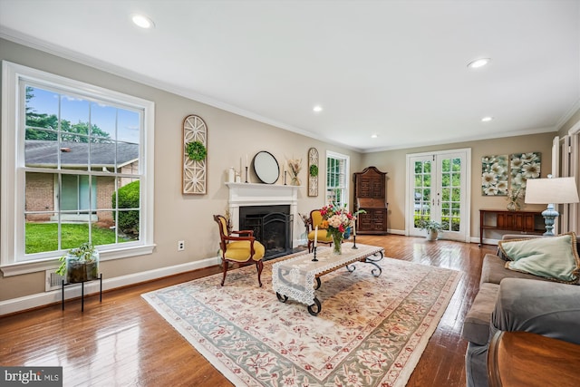 7600 Charleston Dr, Bethesda, MD 20817 - living area featuring crown molding, hardwood / wood-style flooring, a fireplace, recessed lighting, and french doors