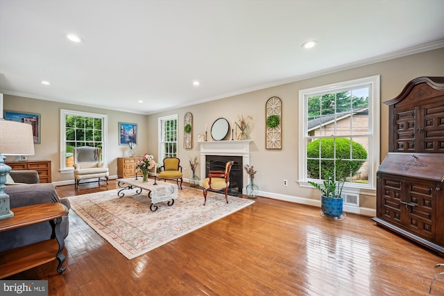 7600 Charleston Dr, Bethesda, MD 20817 - living area featuring healthy amount of natural light, wood finished floors, ornamental molding, recessed lighting, and a fireplace with flush hearth
