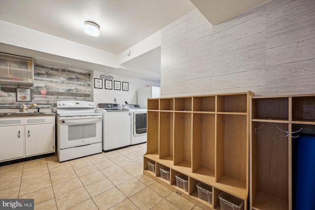 7600 Charleston Dr, Bethesda, MD 20817 - kitchen featuring electric stove, wood walls, light tile patterned flooring, washer and clothes dryer, and open shelves