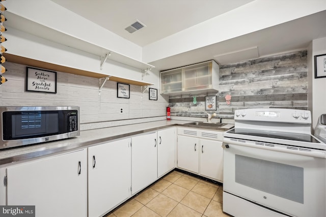7600 Charleston Dr, Bethesda, MD 20817 - kitchen featuring electric range, stainless steel microwave, open shelves, light tile patterned flooring, and tasteful backsplash