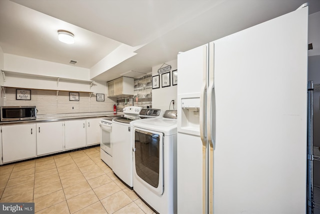 7600 Charleston Dr, Bethesda, MD 20817 - kitchen with stainless steel microwave, white fridge with ice dispenser, stove, separate washer and dryer, and decorative backsplash