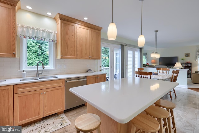 1350 Hyde Park Dr, Lancaster, PA 17601 - kitchen with dishwasher, a sink, a breakfast bar, open floor plan, and decorative backsplash