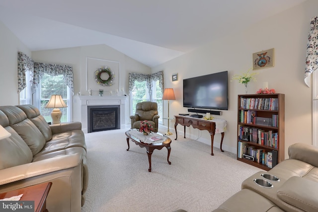 1350 Hyde Park Dr, Lancaster, PA 17601 - carpeted living room with lofted ceiling, healthy amount of natural light, a glass covered fireplace, and baseboards
