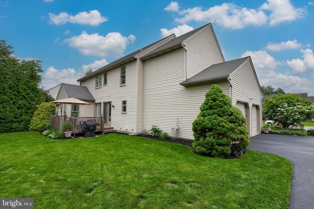 1350 Hyde Park Dr, Lancaster, PA 17601 - view of side of property with a yard, a deck, driveway, an attached garage, and a shingled roof